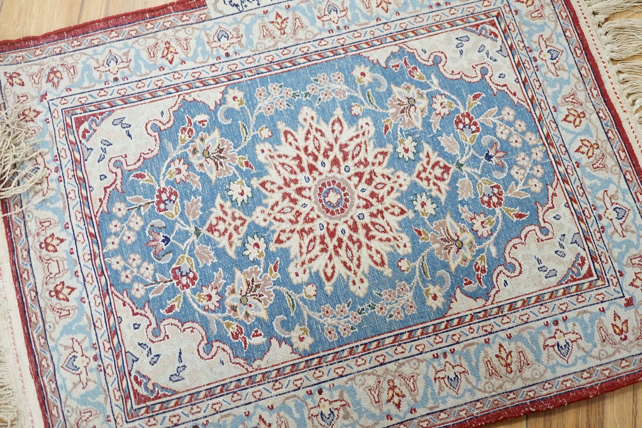 A north-west Persian blue-ground floor mat, signed, 42x53cm